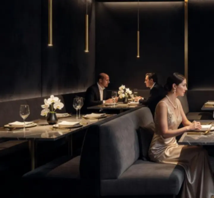 Cinematic interior of Turr Away with emerald and gold accents and warm ambient lighting.